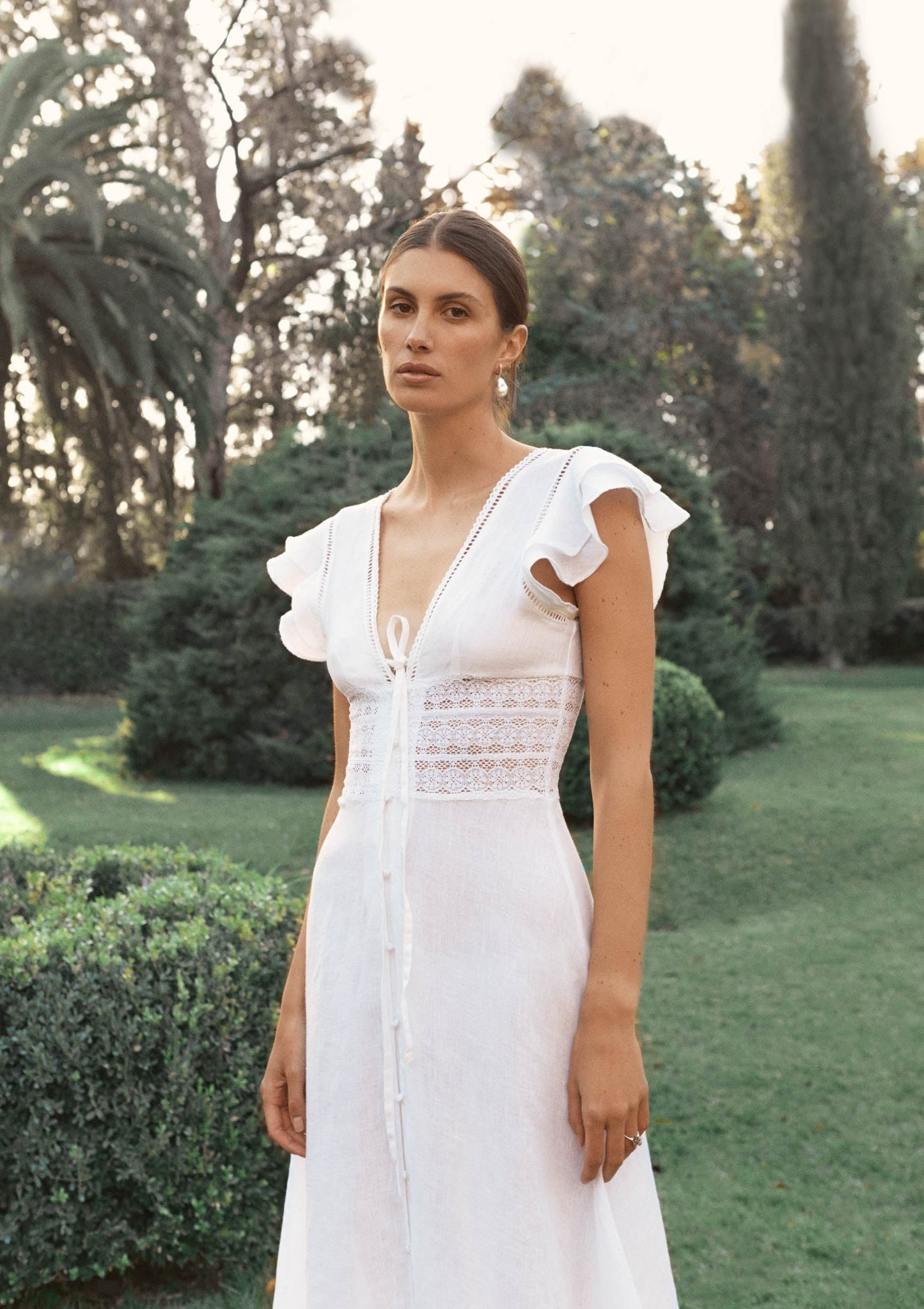 This dreamy dress is perfect for brides-to-be and summer events alike. With delicate lace inserts and trims, ruffled sleeves, and a romantic, versatile white hue, the Basel is your hero white dress. 